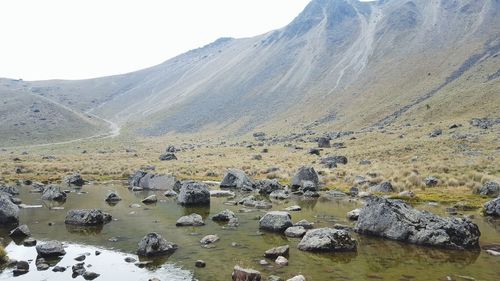Aerial view of lake by mountain against sky