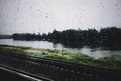 Raindrops on glass window of rainy season