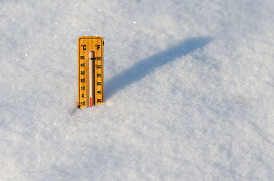 High angle view of information sign on snow covered field