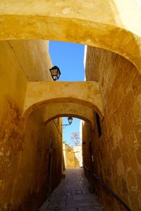 Low angle view of narrow alley amidst old building