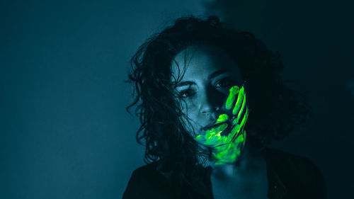 Portrait of young woman against gray background