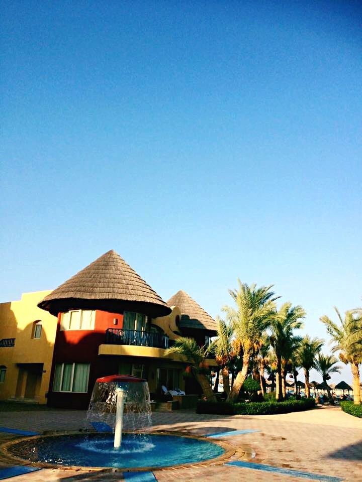 HOUSES AGAINST BLUE SKY