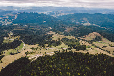High angle view of townscape and mountains against sky