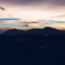 Scenic view of mountains against sky at sunset