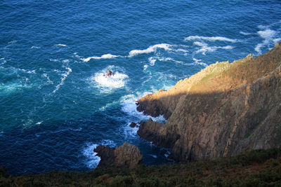 Rocky ocean coastline, crashing waves, cliffs