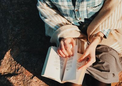 High angle view of woman reading book