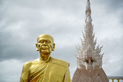 Low angle view of statue against cloudy sky