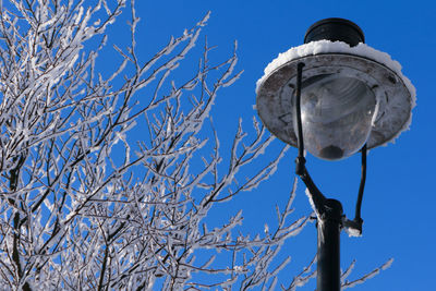 Low angle view of street light against clear blue sky