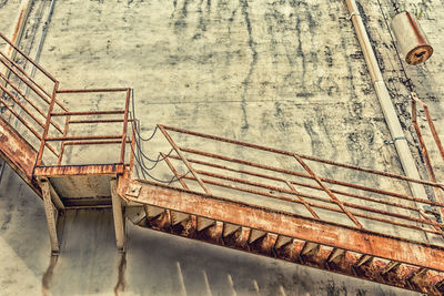 Low angle view of rusty steps against building