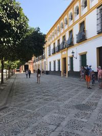 People walking in front of building