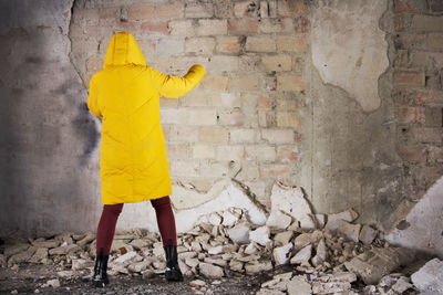 Rear view of woman walking on wall