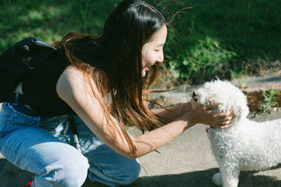 Woman playing dog on road