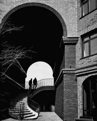 Silhouette men on staircase of building