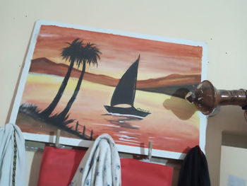 Low angle view of eyeglasses on wall against sky