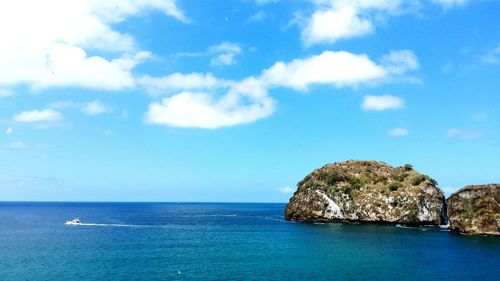 Scenic view of sea against blue sky