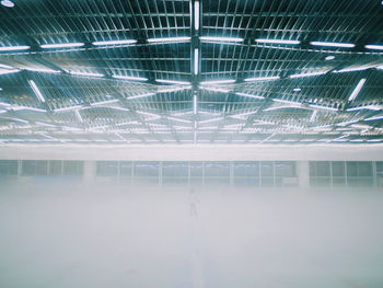 Illuminated building seen through glass ceiling