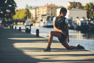 Young woman stretching, uppsala, sweden