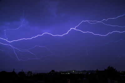 Low angle view of lightning against sky at night