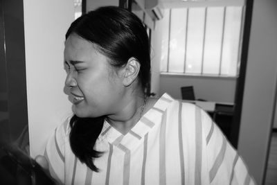 Close-up portrait of teenage girl at home