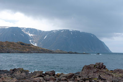 Scenic view of sea and mountains against sky