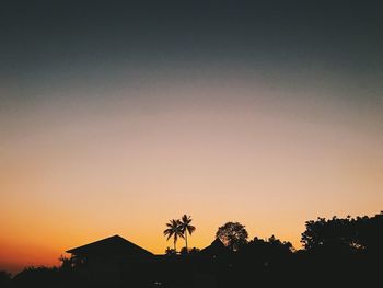 Silhouette trees against sky during sunset