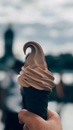 Close-up of hand holding ice cream cone