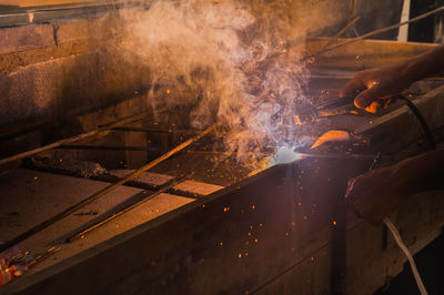 Cropped hand welding rod in factory