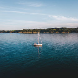 Boat sailing in sea against sky