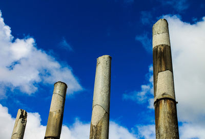 Low angle view of columns against blue sky