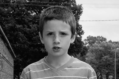 Portrait of boy against trees