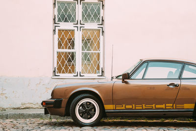 Vintage car parked against wall