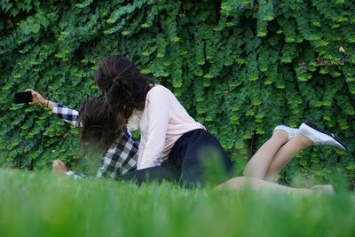 Women taking selfie against plants