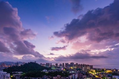 High angle view of illuminated buildings against sky during sunset