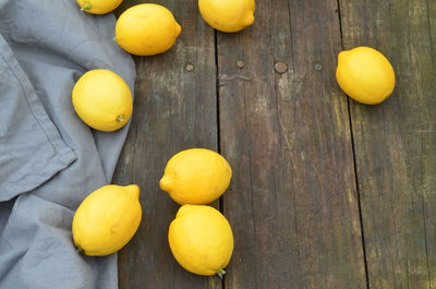Fresh lemons on rustic wood tabletop