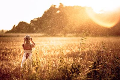 Woman standing on grassy field