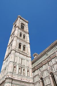 Low angle view of building against clear blue sky