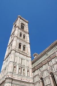 Low angle view of giotto campanile against clear blue sky