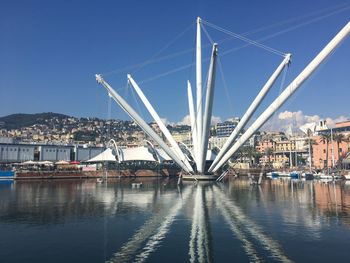 Bridge over river against clear blue sky