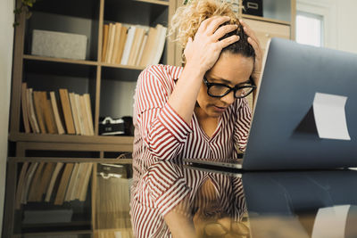 Frustrated woman sitting at office