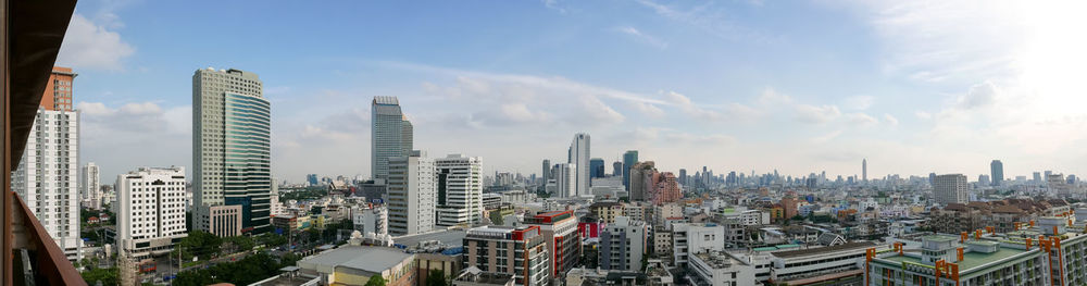 Panoramic view of cityscape against cloudy sky