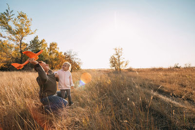 Happy father and child having fun playing outdoors. young dad and daughter, let an airplane in sky