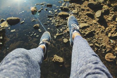 Legs over river in summer