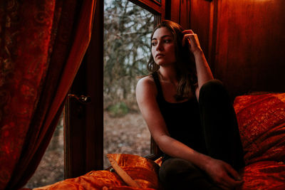 Young woman sitting in mirror