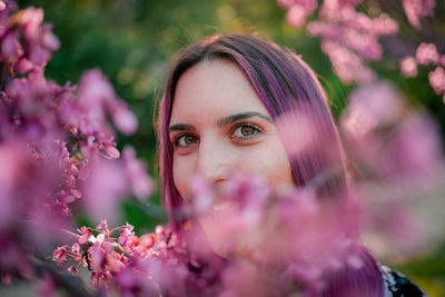 Portrait of woman with pink flowers