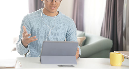 Mid adult man using laptop on table