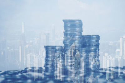 Digital composite image of modern buildings in city against sky