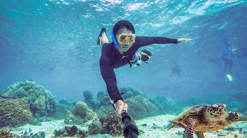 Portrait of young woman swimming in sea