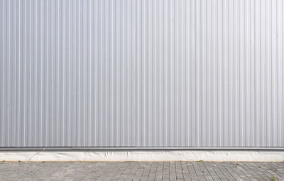 Sheet metal, corrugated wall building