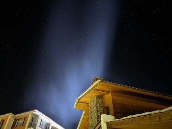 Low angle view of illuminated building against sky at night