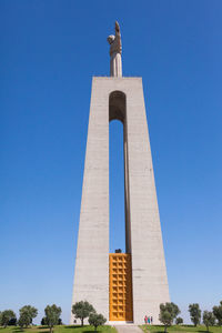 Low angle view of statue against blue sky